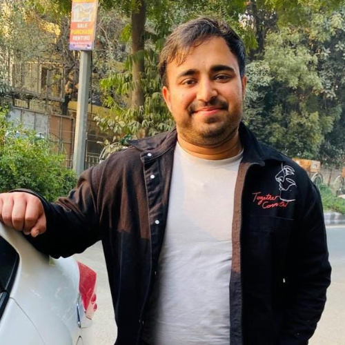 a man resting his hand on a car