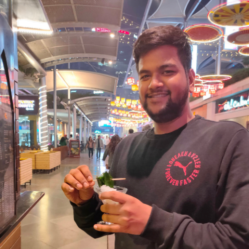 a man holding a glass of beverage